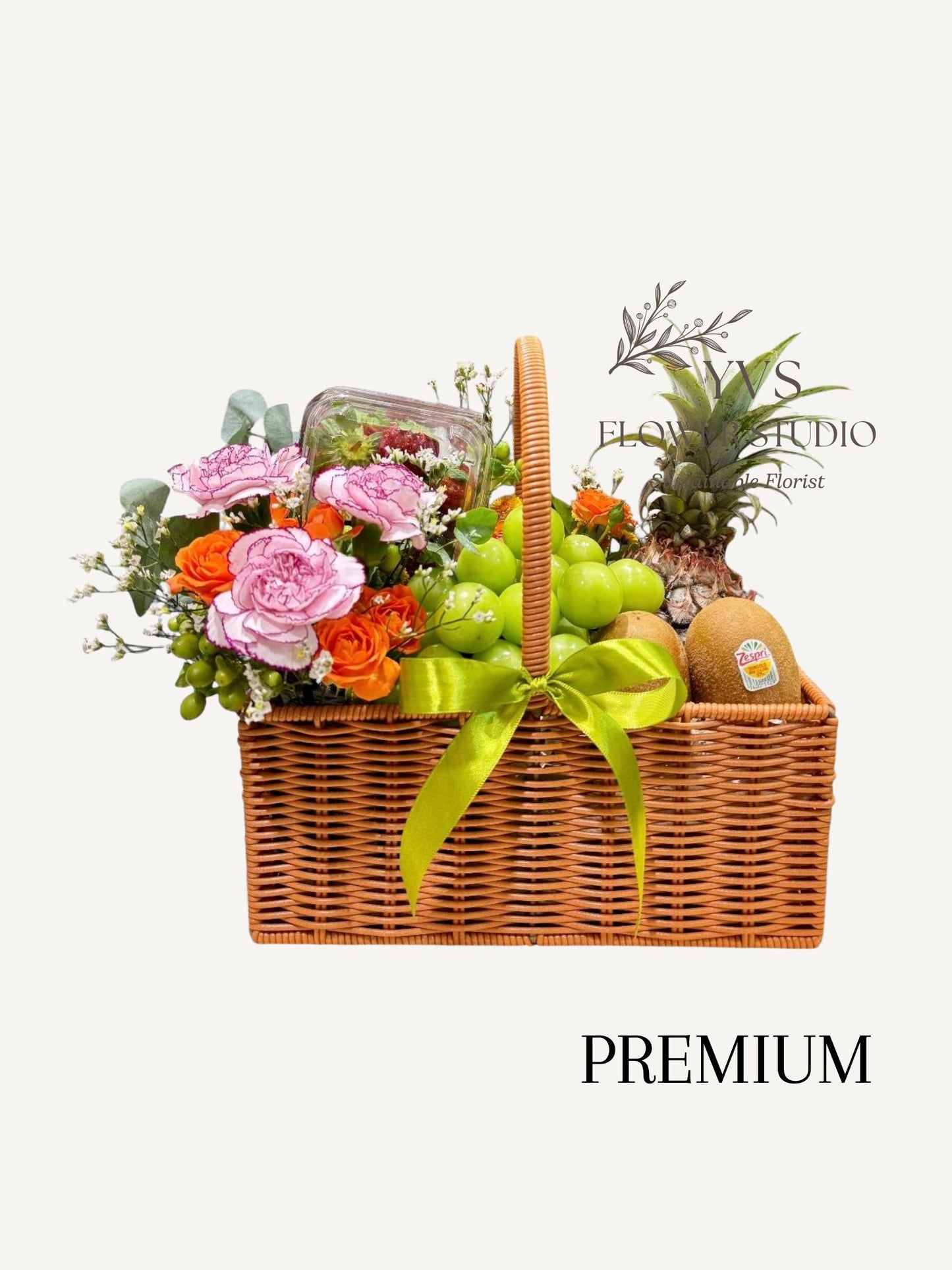 Premium Fruit basket with 6-8 varieties of fruits and fresh flowers on the side.