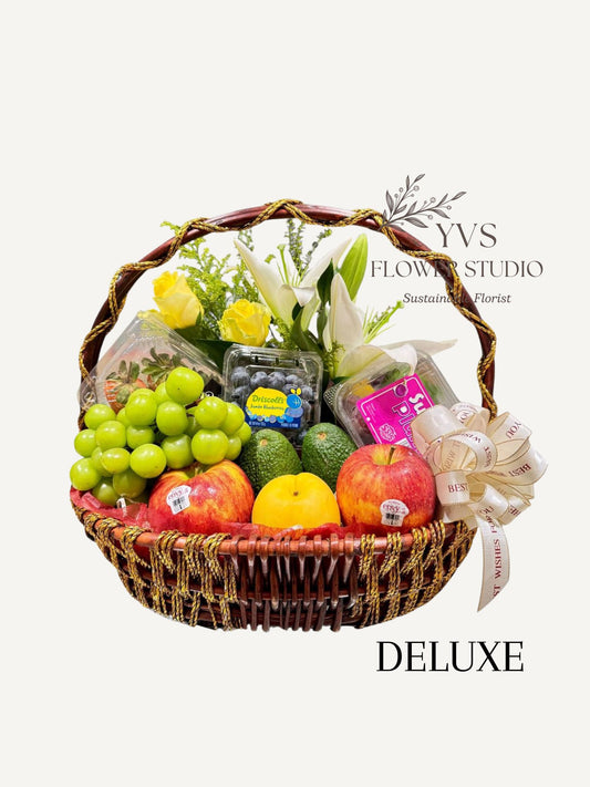 Deluxe Fruit basket with 6-8 varieties of fruits and fresh flowers on the side. 