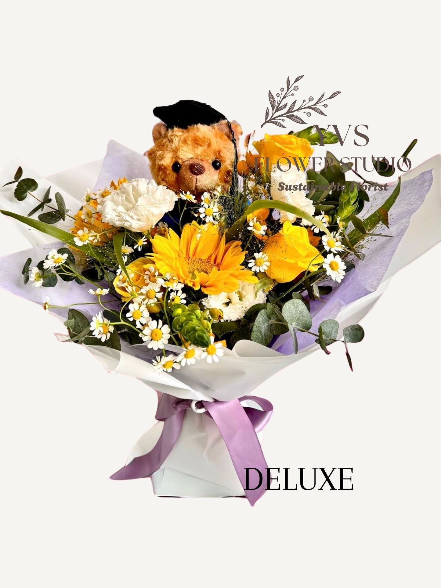 Graduation bouquet with bear , lush sunflower arrangement and lilac wrappers.