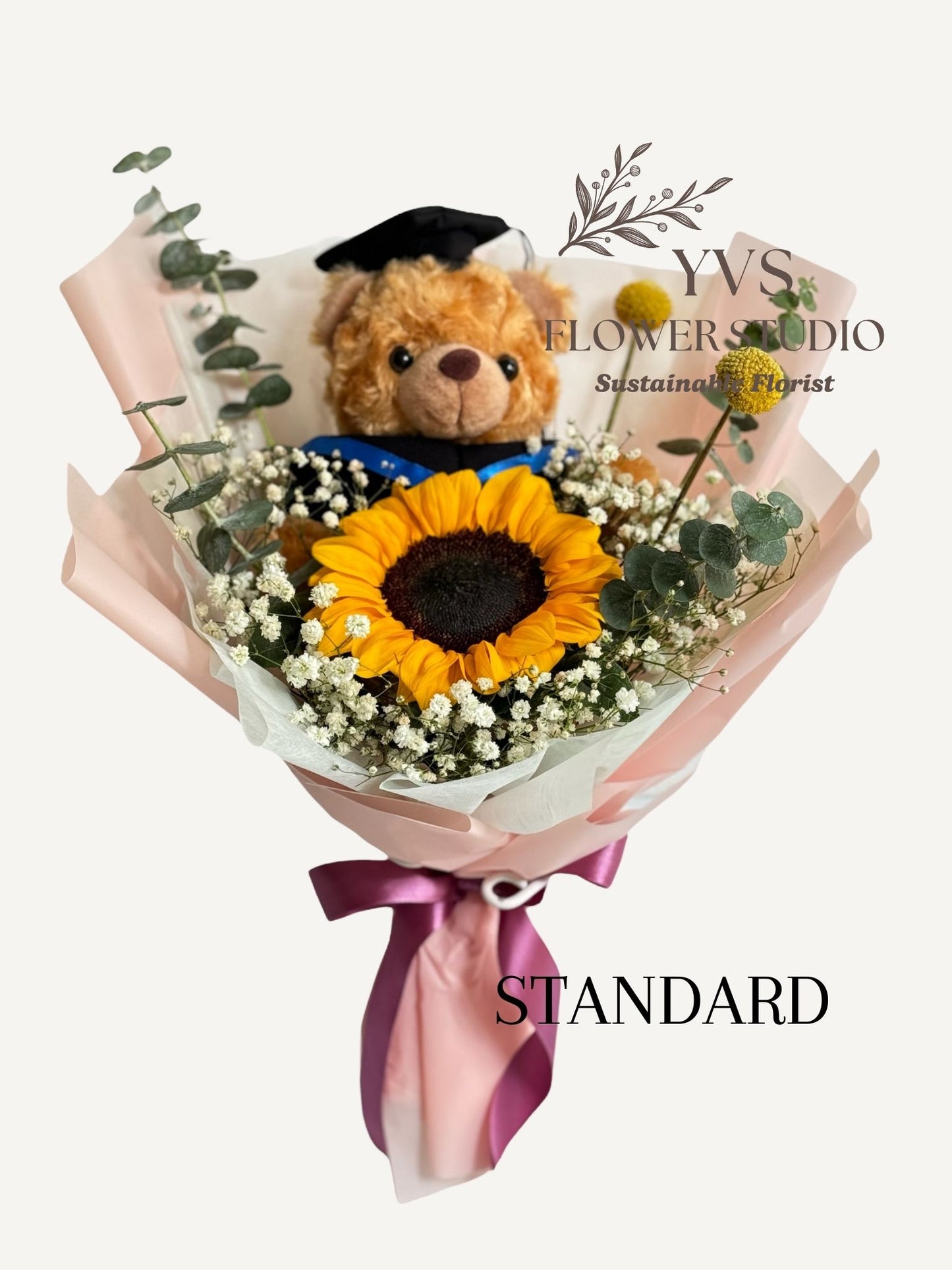 Graduation bouquet with bear , sunflower and pink wrappers.