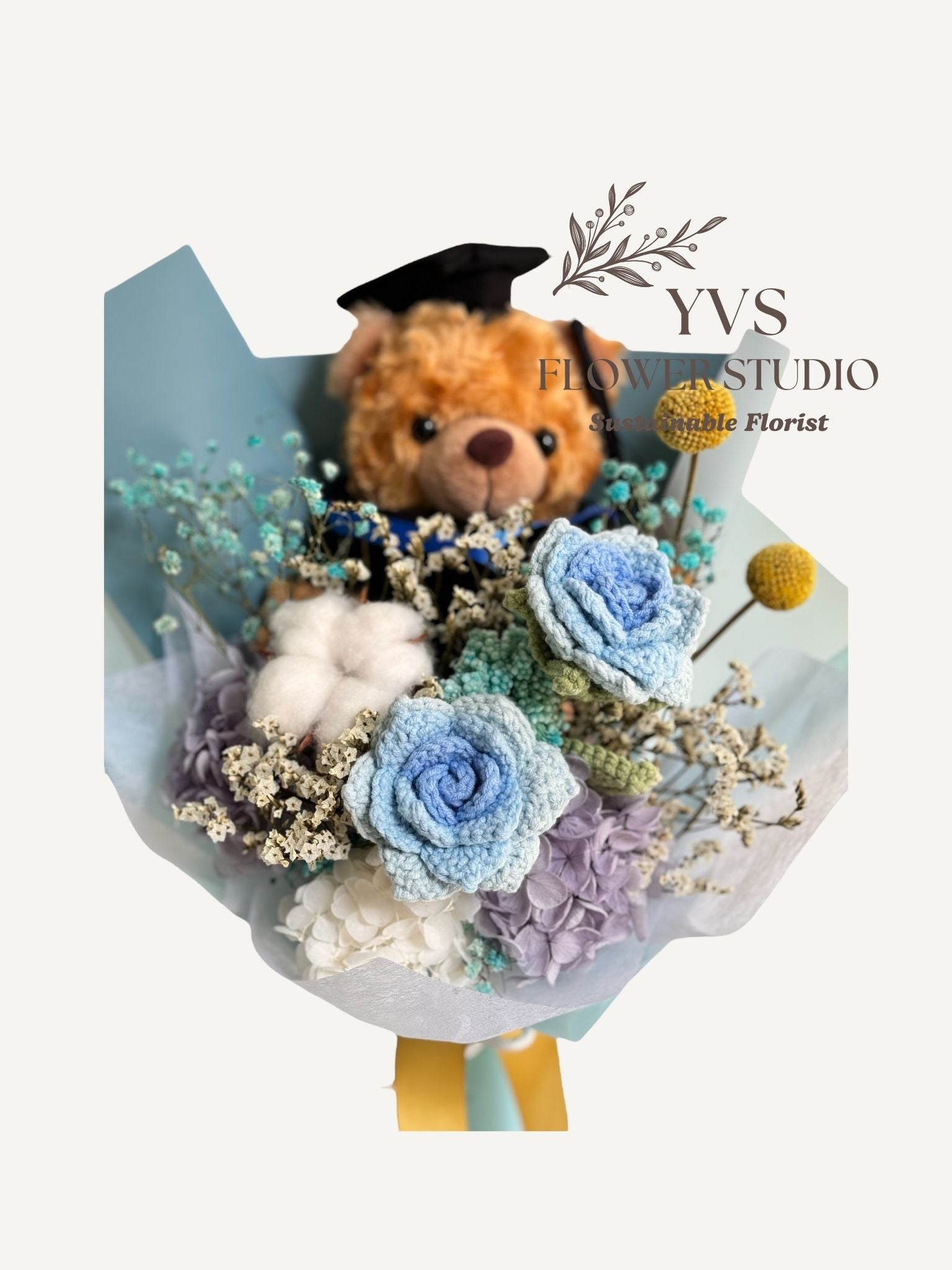 Graduation Bear with blue crochet and preserved flowers bouquet close up view