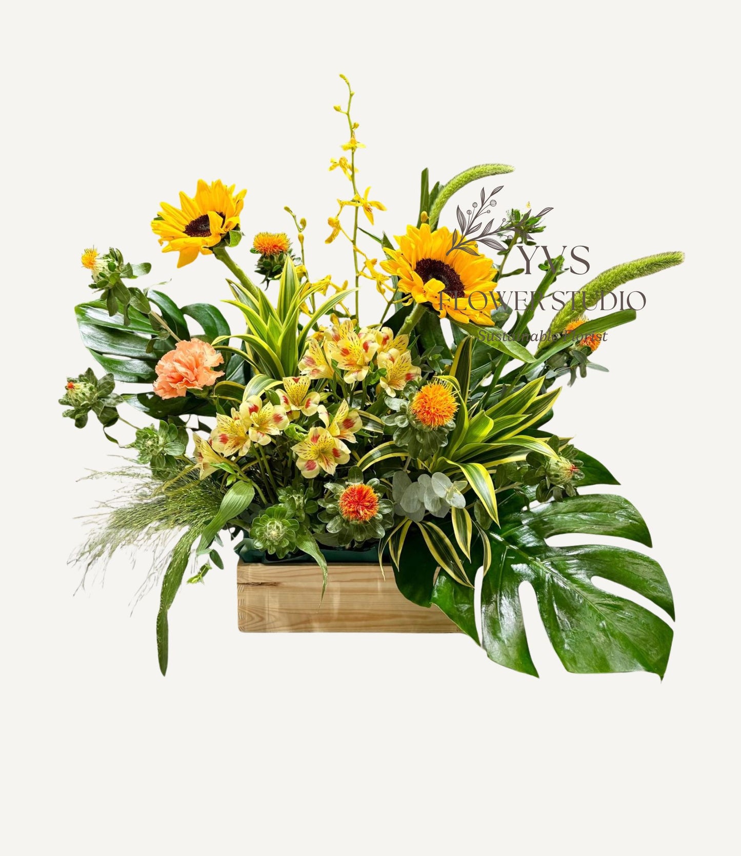 A table top arrangement consisting of a vibrant mix of yellow and orange flowers and foliage