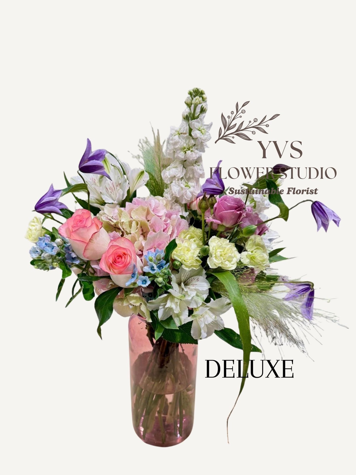 Bouquet of pastel themed flowers in a vase with YVS Flower Studio branding on a white background