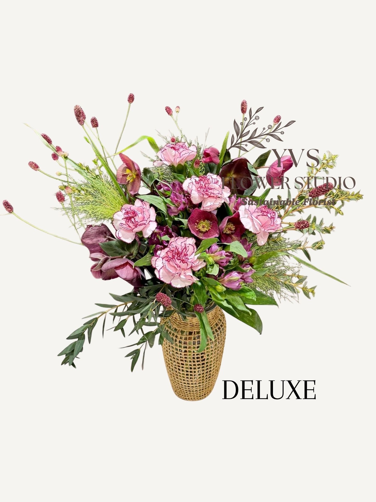 Purple themed flower arrangement in a vase 