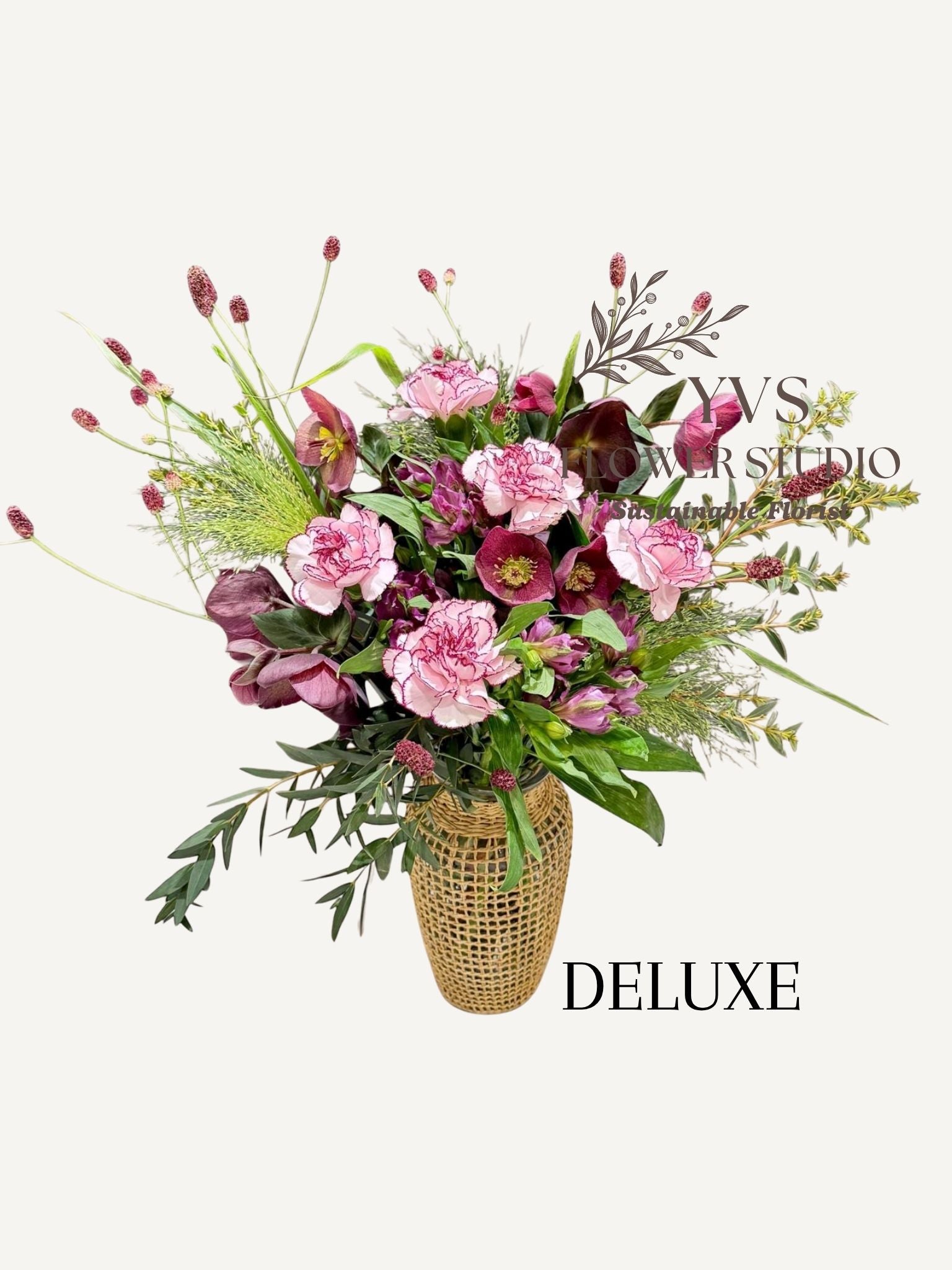 Purple themed flower arrangement in a vase 